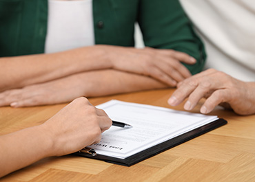 Family discussing probate documents with a lawyer in Travis County, Texas.